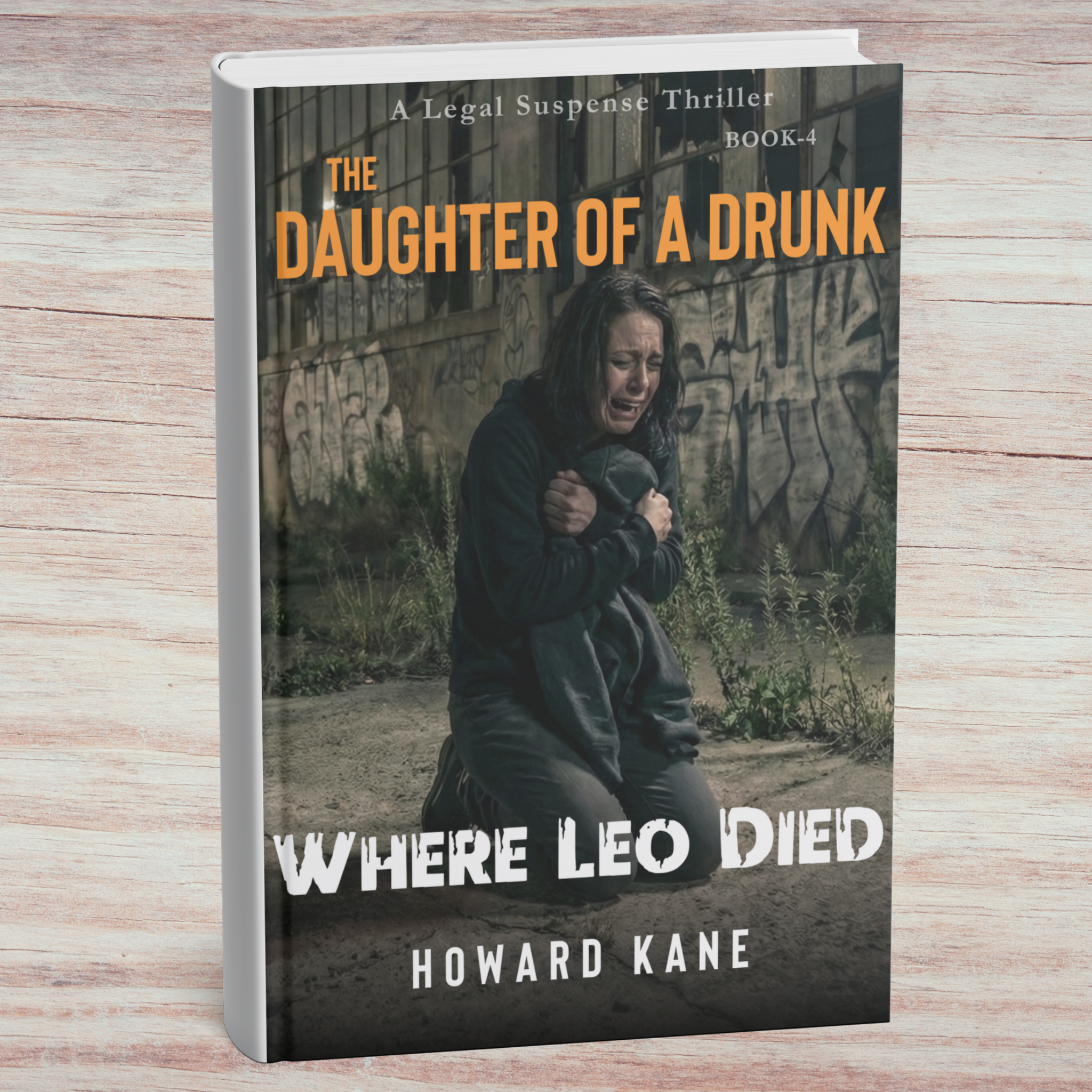 Book cover of 'The Daughter of a Drunk Where Leo Died' by Howard Kane on a wooden surface.