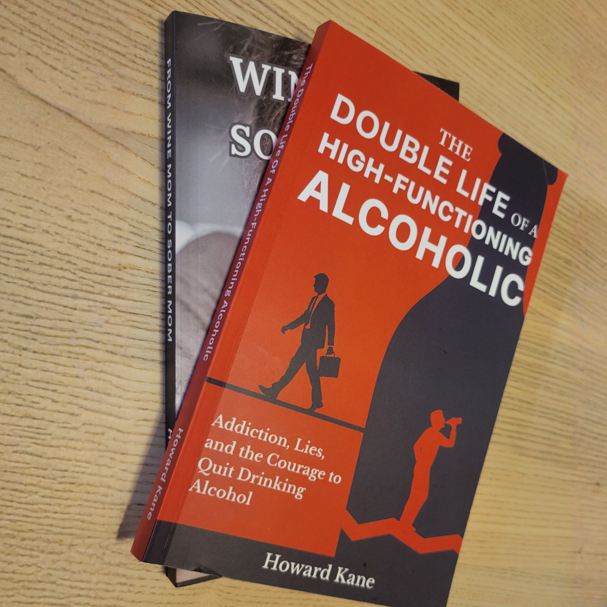 Book titled 'The Double Life of a High Functioning Alcoholic' on a wooden surface