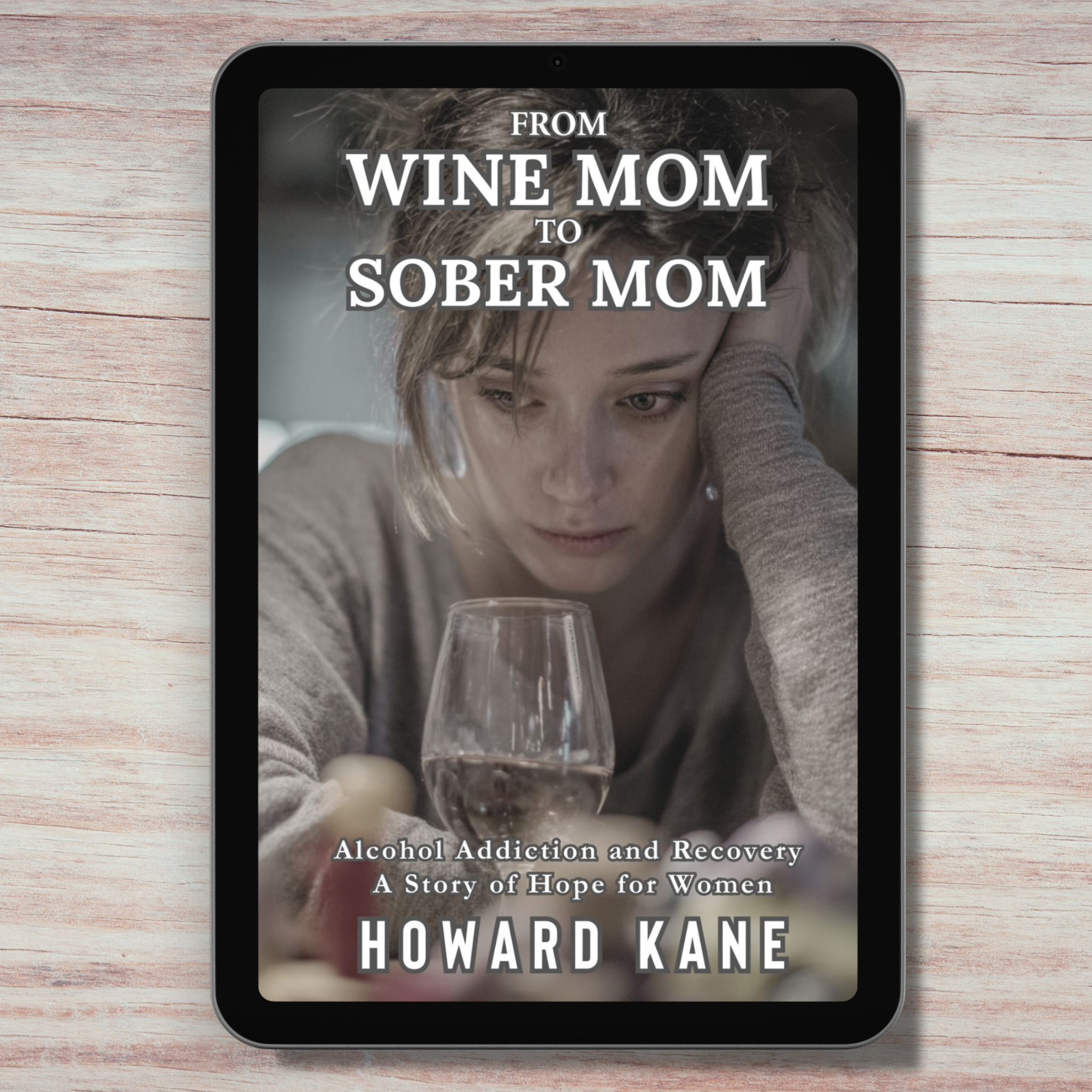 Book cover of 'From Wine Mom to Sober Mom' by Howard Kane on a wooden surface